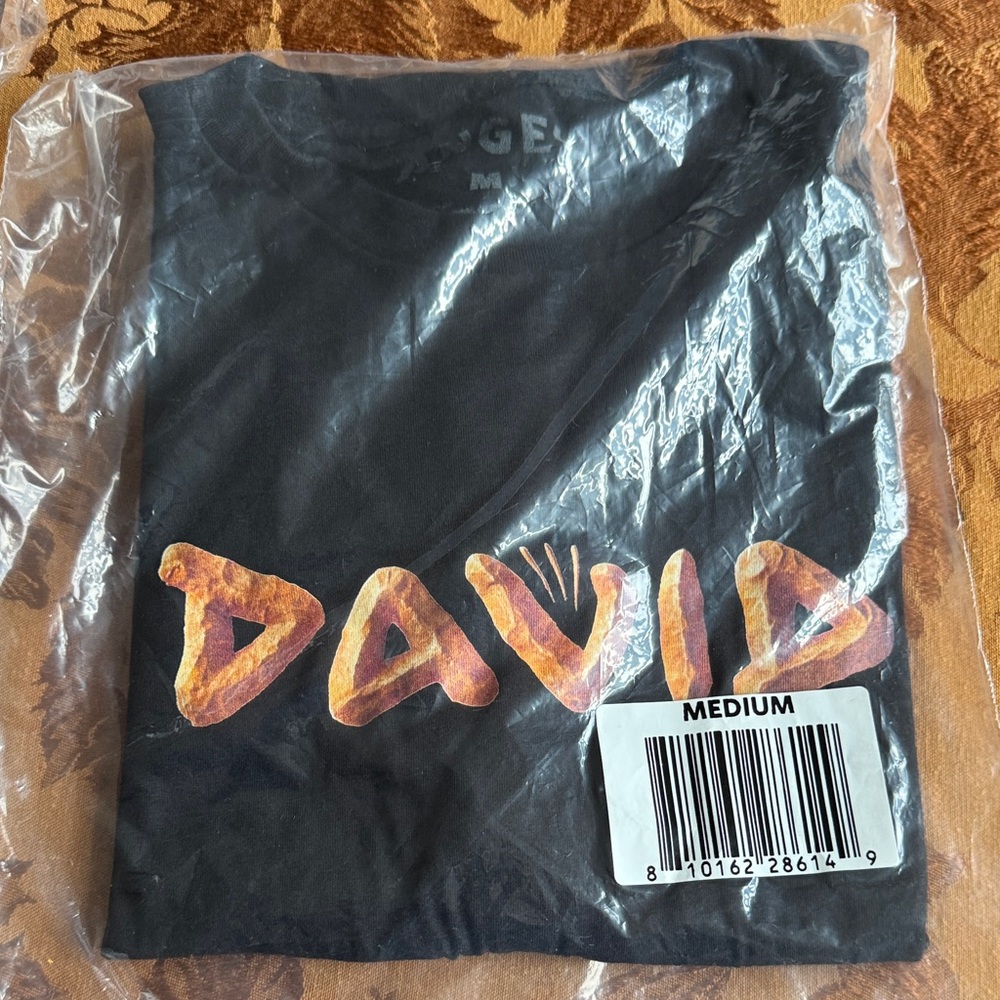 Black DAVID Graphic T-Shirt with Orange branding. Angel Studios